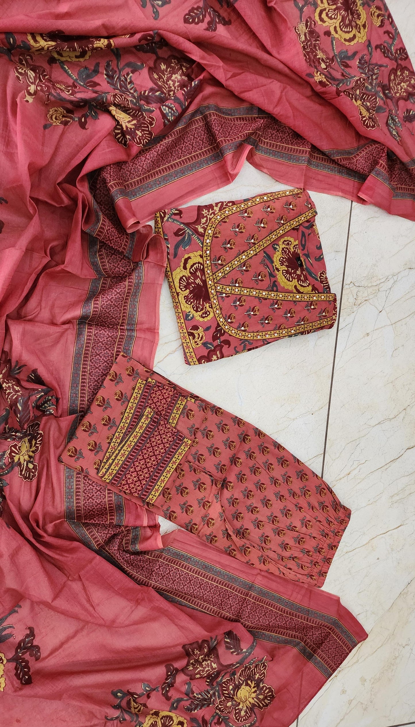 Premium cotton Anarkali suit set with hand work detailing on yoke paired with matching pant and full dupatta.(SWRED60)