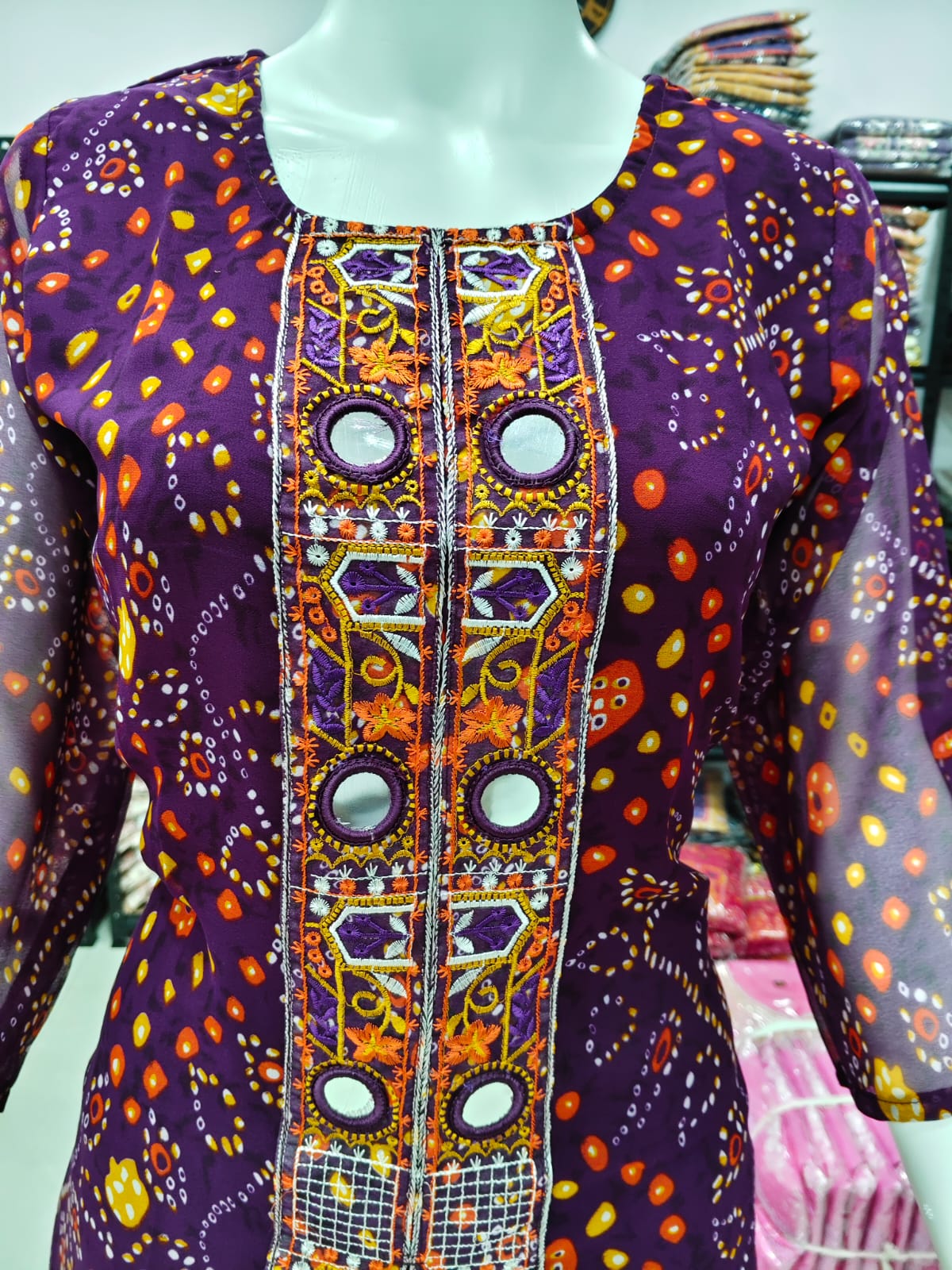 A Rich Purple And Pink Bandhani Printed Plazo set Featuring An Embroidered Front Panel, Flowy Matching Bottoms and A Sheer Dupatta For An Elegant Ethnic Look. (NFRD01)