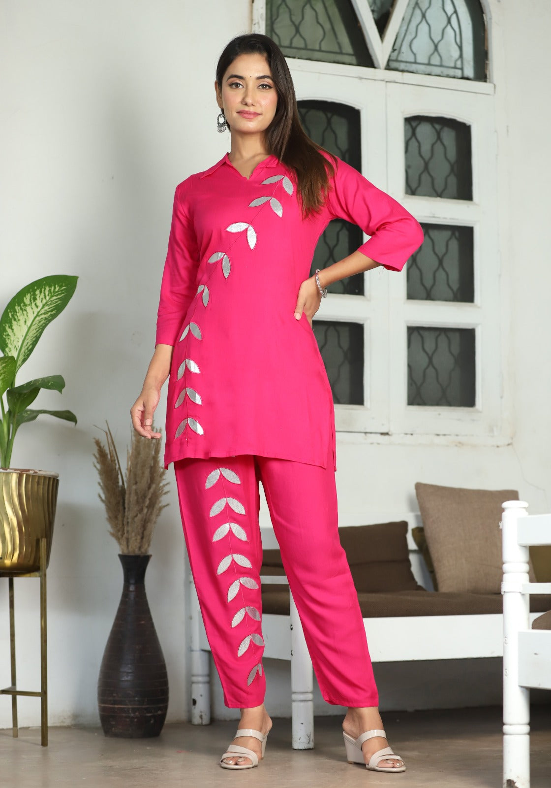 A mirror work kurti paired with pants exudes timeless charm and contemporary elegance