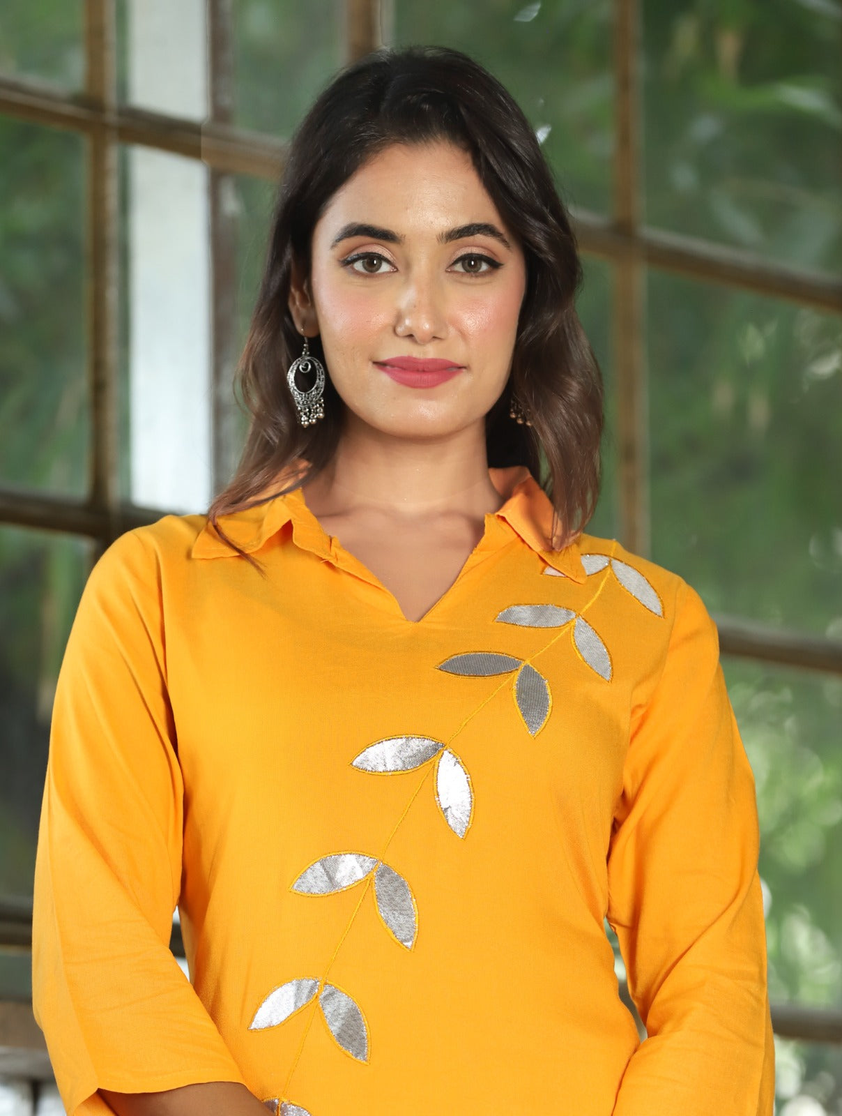 A mirror work kurti paired with pants exudes timeless charm and contemporary elegance