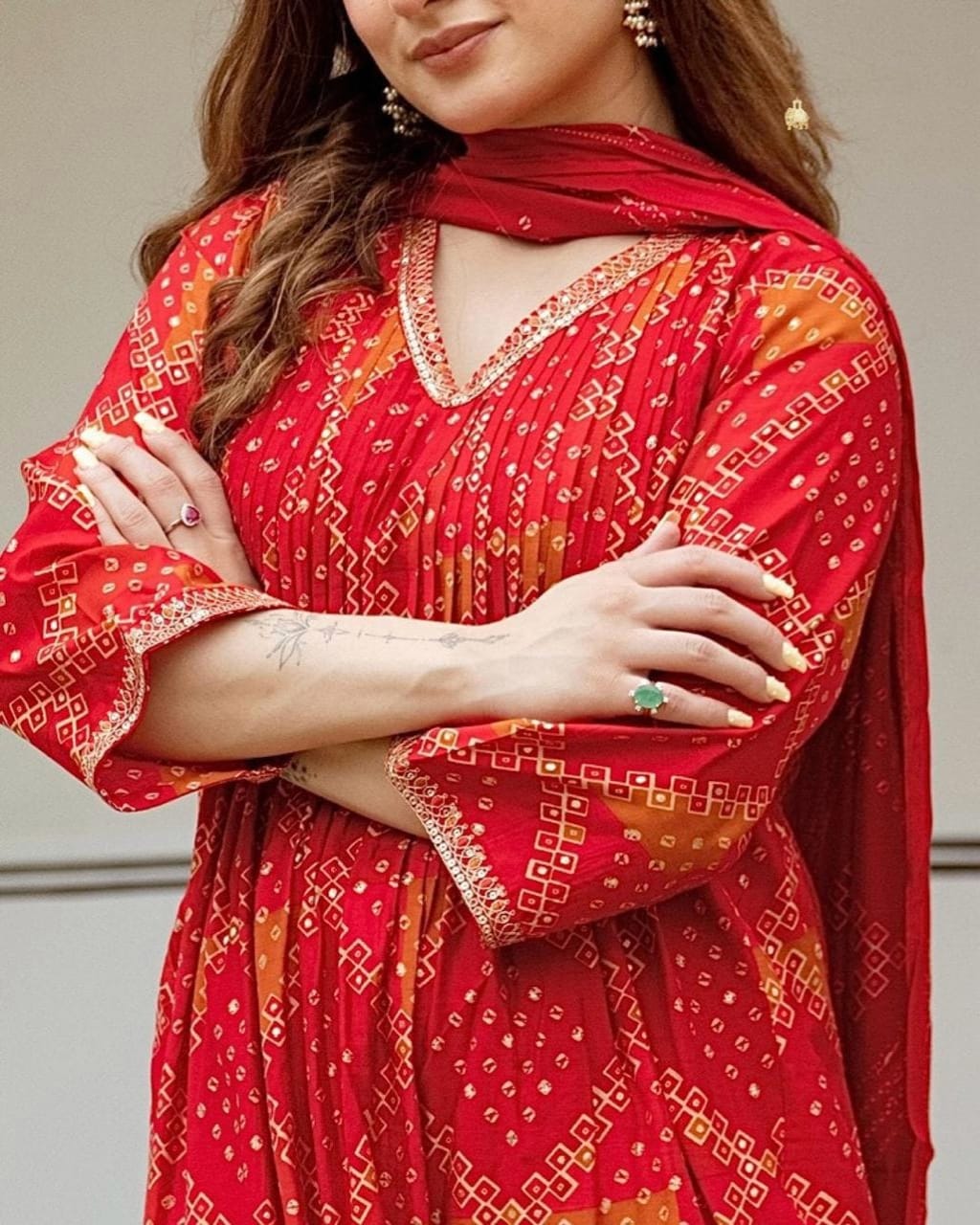 Radiate grace this Karwa Chauth in our finely crafted Red Cotton Suit with intricate embroidery and timeless Bandhani print all-over