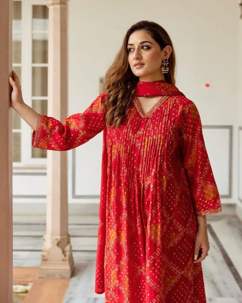 Radiate grace this Karwa Chauth in our finely crafted Red Cotton Suit with intricate embroidery and timeless Bandhani print all-over