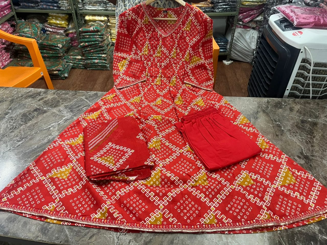 Radiate grace this Karwa Chauth in our finely crafted Red Cotton Suit with intricate embroidery and timeless Bandhani print all-over