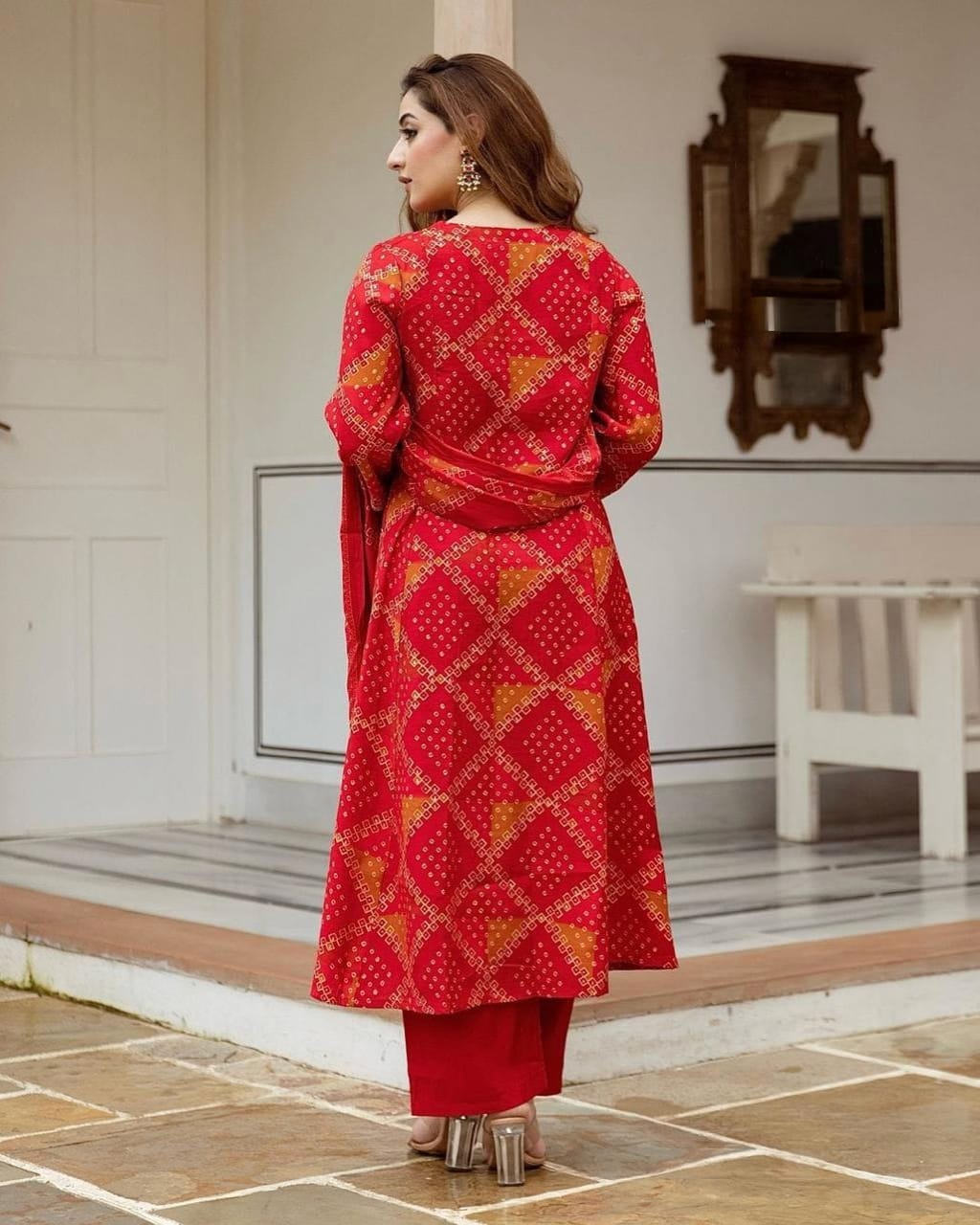 Radiate grace this Karwa Chauth in our finely crafted Red Cotton Suit with intricate embroidery and timeless Bandhani print all-over