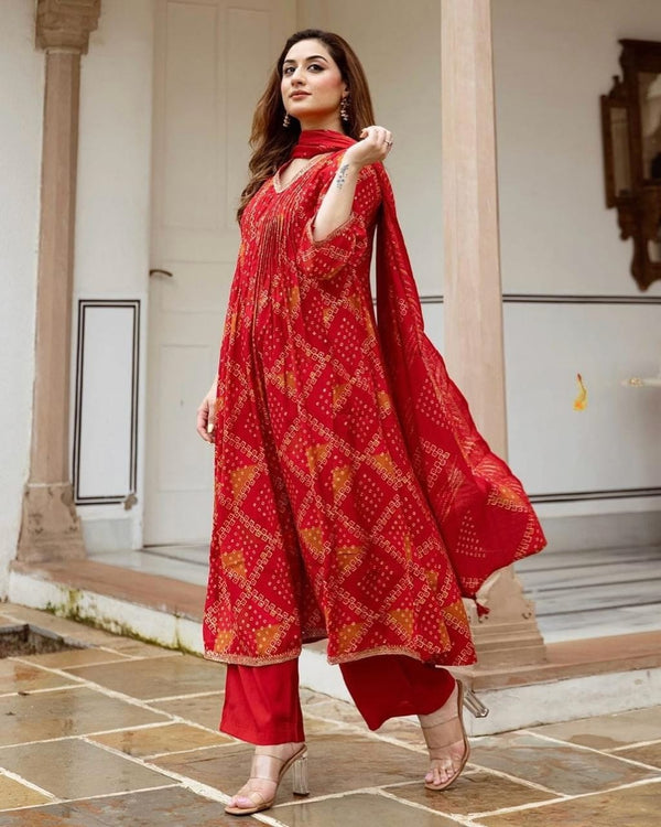 Radiate grace this Karwa Chauth in our finely crafted Red Cotton Suit with intricate embroidery and timeless Bandhani print all-over