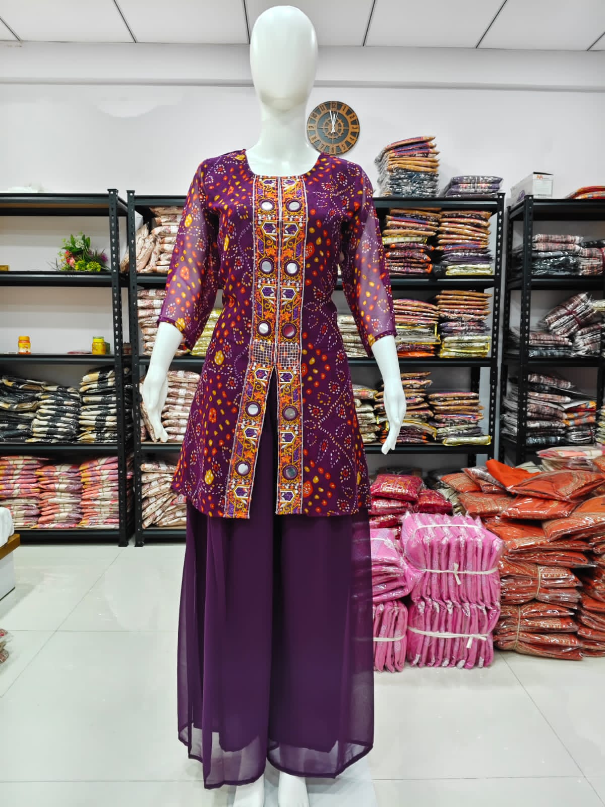 A Rich Purple And Pink Bandhani Printed Plazo set Featuring An Embroidered Front Panel, Flowy Matching Bottoms and A Sheer Dupatta For An Elegant Ethnic Look. (NFRD01)