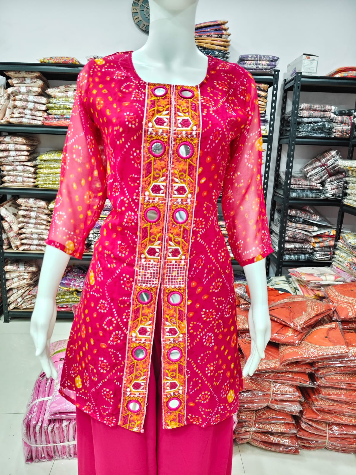 A Rich Purple And Pink Bandhani Printed Plazo set Featuring An Embroidered Front Panel, Flowy Matching Bottoms and A Sheer Dupatta For An Elegant Ethnic Look. (NFRD01)